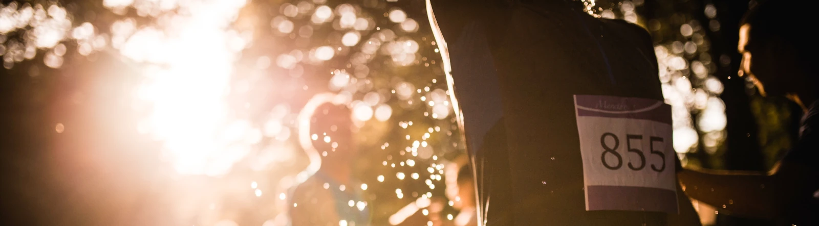 A close-up of marathon runners with splashes of water