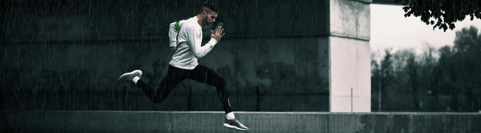 A man running quickly in the rain
