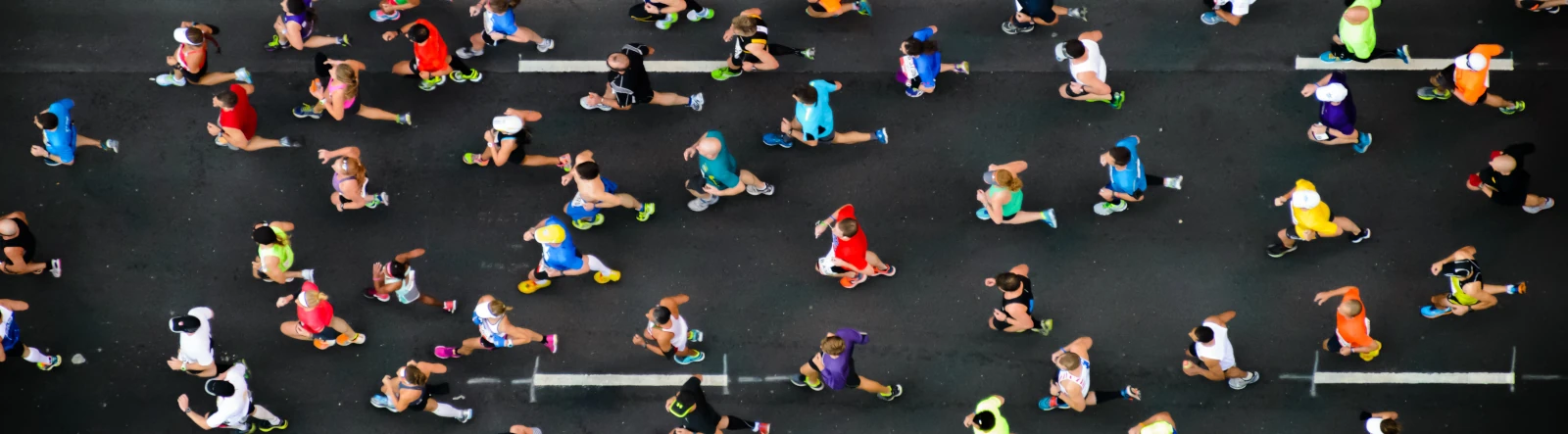 An aerial view of several runners on the road
