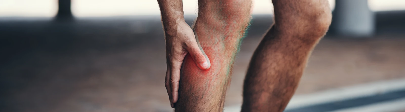 A runner holding his shin, which appears inflamed