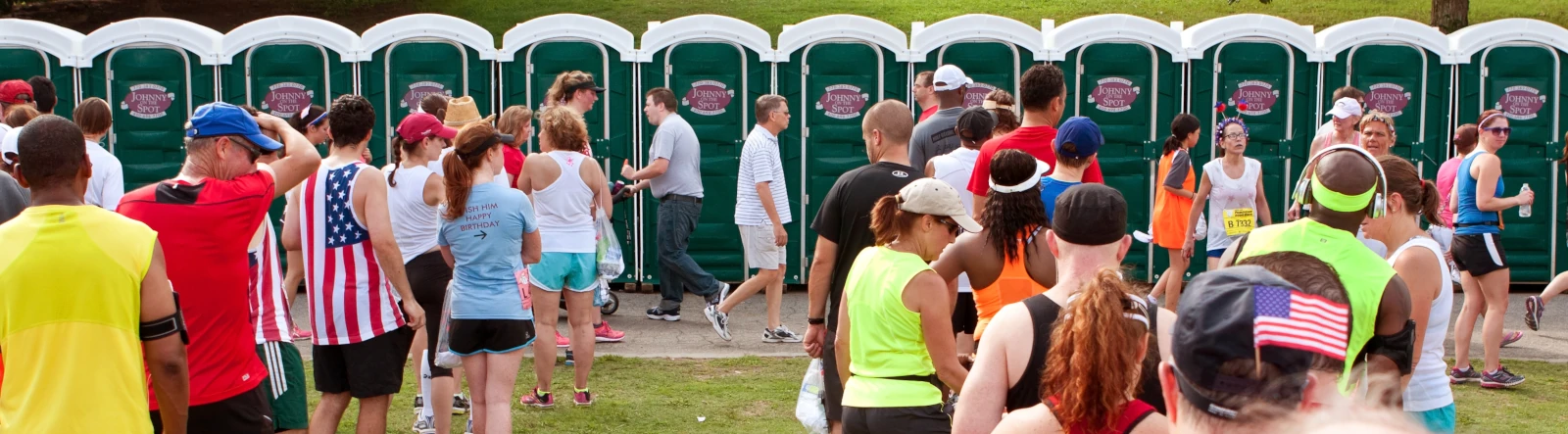 Lines of runners waiting to use portable toilets