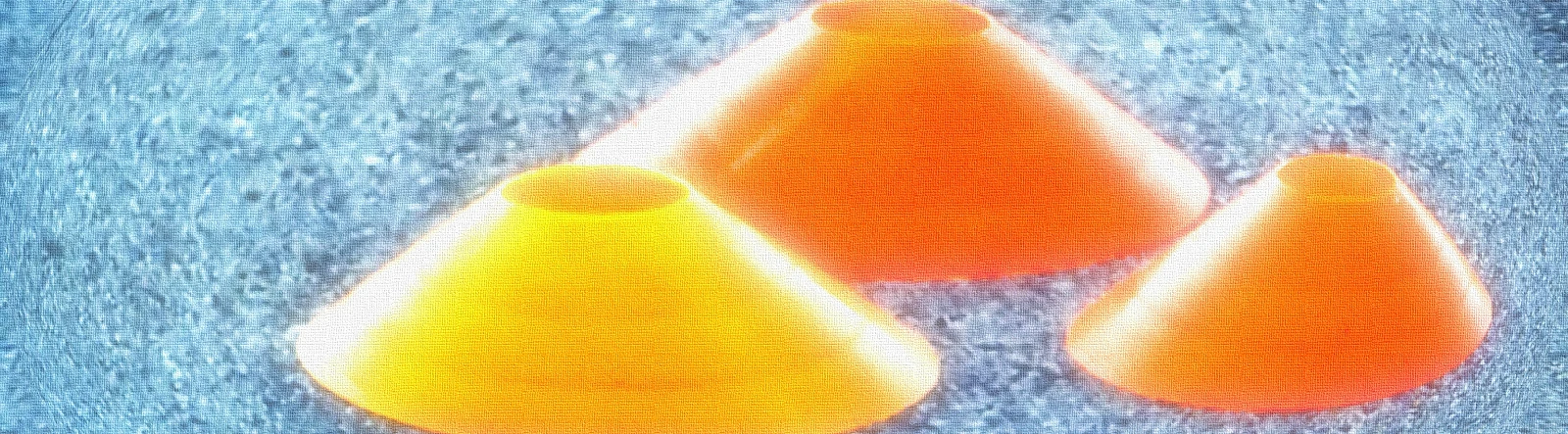 Three glowing orange flexi cones on a blue background